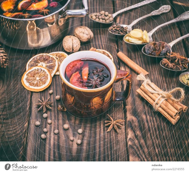 mulled wine in a brown cup Fruit Herbs and spices Beverage Alcoholic drinks Mulled wine Cup Spoon Winter Decoration Table Feasts & Celebrations
