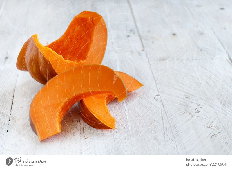 Pumpkin slices on a white wooden background Vegetable Nutrition Eating Vegetarian diet Thanksgiving Hallowe'en Autumn Fresh Natural Yellow agriculture cooking