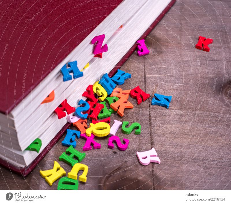 wooden letters fall out of a closed book Table Book Wood Reading Blue Brown Pink Red Idea Study School Information colorful cover alphabet knowledge