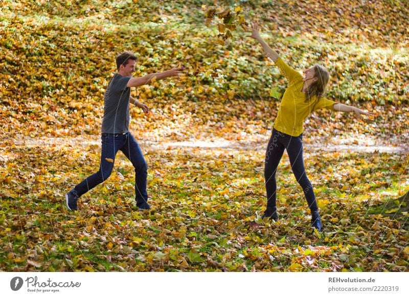 Couple makes a leaf fight in autumn Young man Young woman Adults Woman Man Partner 18 - 30 years Environment Nature Autumn Beautiful weather naturally Funny