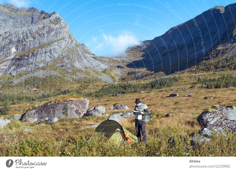 Young man with map in front of tent and mountain panorama Vacation & Travel Adventure Mountain Hiking Youth (Young adults) Landscape Beautiful weather Rock Peak