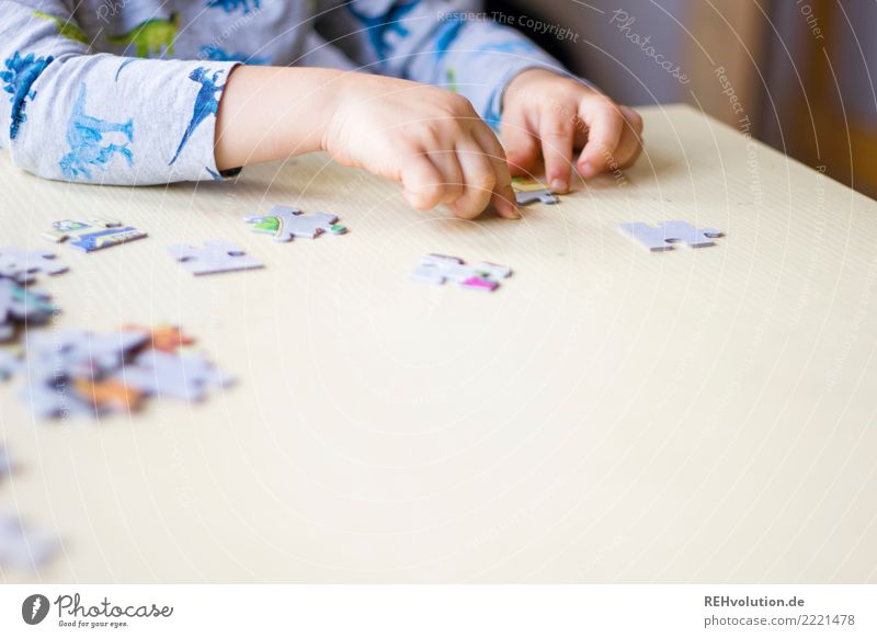 Child doing a puzzle Puzzle 3 - 8 years Infancy Playing Leisure and hobbies Hand Table Orderliness Endurance Disciplined Patient Boredom Interior shot Close-up