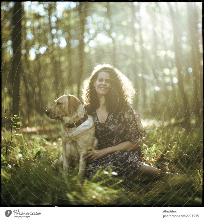 analog medium format picture of young blond Labrador with young dark haired woman with wild curls in forest in back light Happy pretty Harmonious Well-being