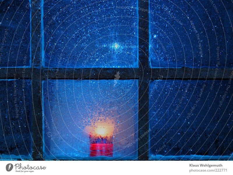 Lonely candle burns behind rusty muntin window with ice trees Calm Decoration Winter Ice Frost Building Window Glass Crystal Freeze Illuminate Blue Gold Black
