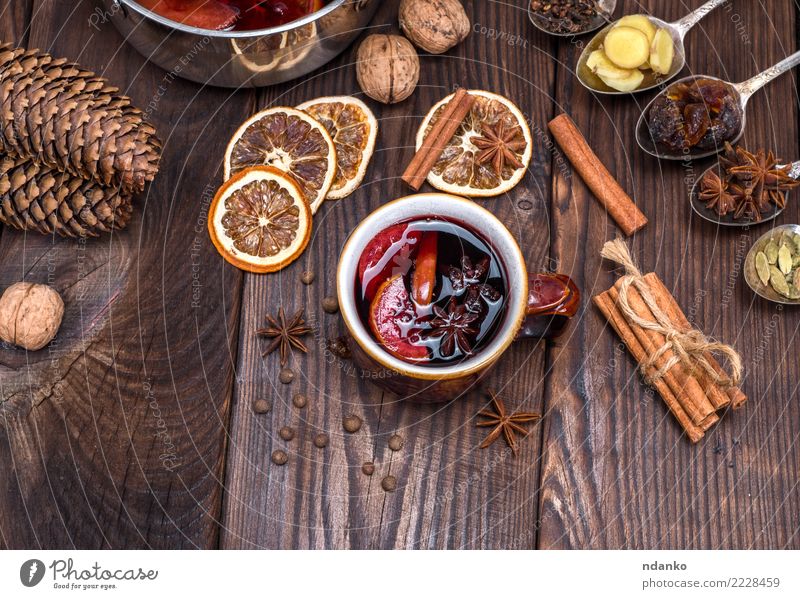 mulled wine in a brown cup Fruit Herbs and spices Beverage Alcoholic drinks Mulled wine Cup Spoon Decoration Table Feasts & Celebrations Christmas & Advent