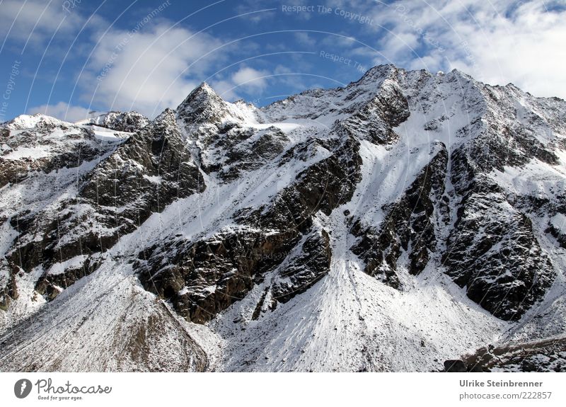 Snow-covered mountain peaks on the Rettenbach glacier Landscape Sky Clouds Sunlight Autumn Beautiful weather Ice Frost Rock Alps Mountain Snowcapped peak