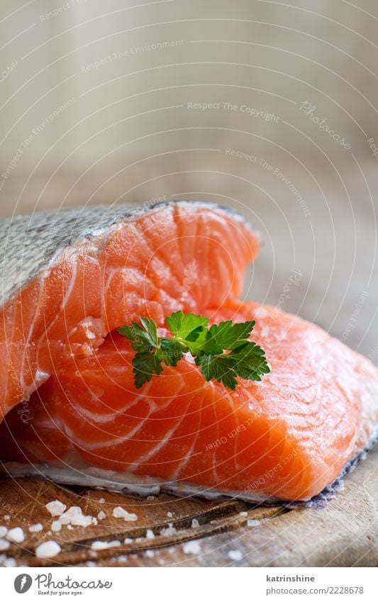 Fresh raw salmon on a wooden cutting board Seafood Herbs and spices Nutrition Eating Dinner Diet Table Green Red background cooking fillet fish healthy