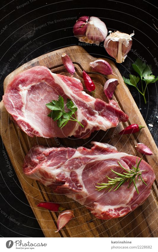 Raw pork steaks called capicola with vegetables and herbs Meat Vegetable Herbs and spices Nutrition Dinner Fresh Above Green Red capicolla board butcher cooking