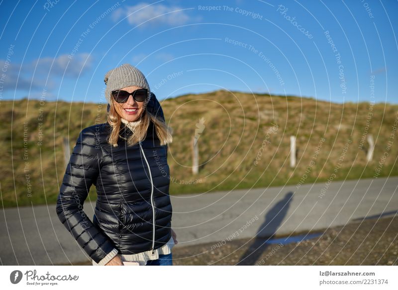 Trendy woman wearing a leather jacket Happy Contentment Woman Adults 1 Human being Landscape Autumn Street Fashion Jacket Sunglasses Blonde Smiling Stand