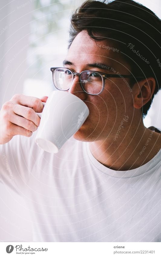 Asian young adult drinking cup of fresh coffee in the morning Drinking Coffee Espresso Tea Lifestyle Joy Relaxation House (Residential Structure) Restaurant Man