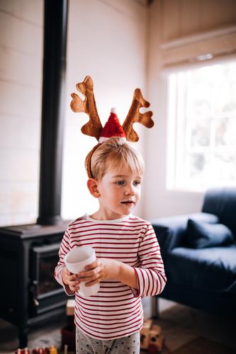 Cute toddler wearing reindeer ear costume on christmas day Drinking Lifestyle Joy Happy Winter House (Residential Structure) Living room Christmas & Advent