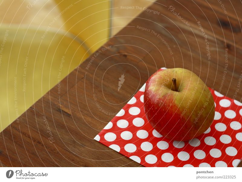 A Boskop apple lies on a table in front of a yellow vintage chair. Healthy food, fruit Food apples Nutrition Decoration Kitsch wood Esthetic Hip & trendy Brown