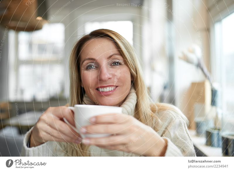 Beautiful woman relaxing at home with coffee Beverage Drinking Coffee Tea Happy Face Calm House (Residential Structure) Living room Woman Adults 1 Human being