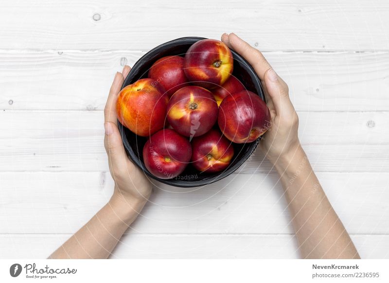 Female hands holding a bowl of nectarine Food Fruit Nectarine Nutrition Eating Breakfast Lunch Bowl Pot Cup Mug Nature Summer Diet Feeding Hand Mock-up Tabletop