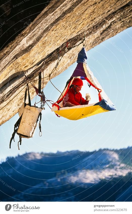 Rock climber bivouaced in a portaledge. Life Adventure Camping Sports Climbing Mountaineering Rope Man Adults 1 Human being Peak Helmet Athletic Tall