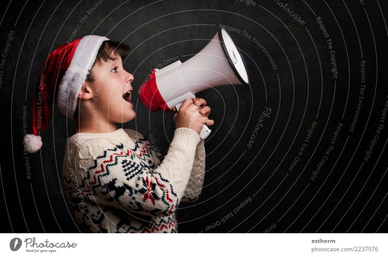 boy with a megaphone at christmas on black background Lifestyle Joy Entertainment Party Event Feasts & Celebrations Christmas & Advent New Year's Eve