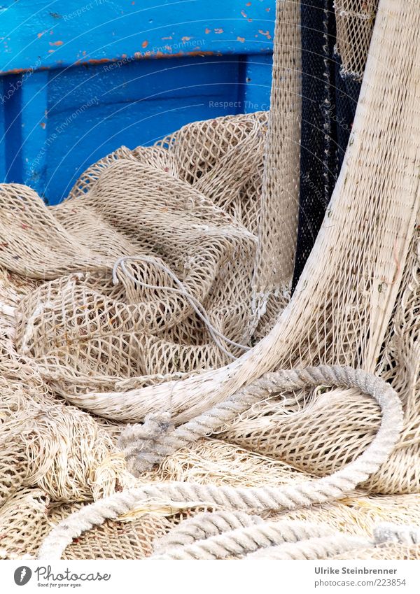 Hanging fishing net on a blue wooden boat Work and employment Fishery Fishing boat Fishing net Navigation Watercraft Rope Lie Firm Ship's side