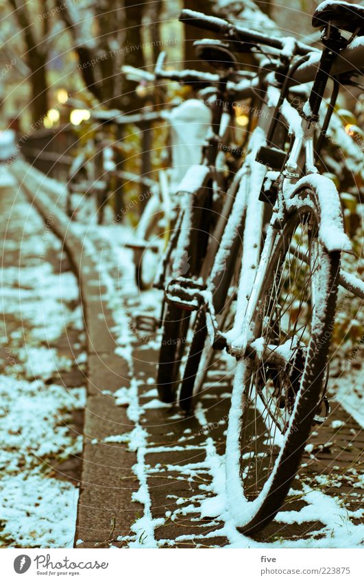 Hamburg Bicycle Parking Winter Snow Places Street Dark Cold Bicycle saddle Pedal Bicycle handlebars Ground Cobblestones Light Bridge railing Bicycle tyre