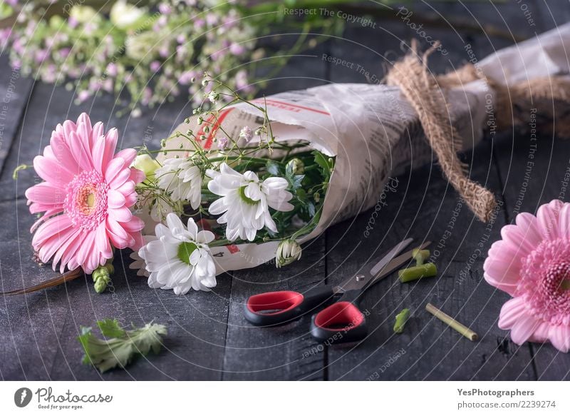 Flowers wrapped in newspaper Design Beautiful Decoration Feasts & Celebrations Birthday Scissors Friendship Blossom Packaging Bouquet Love Happiness Emotions