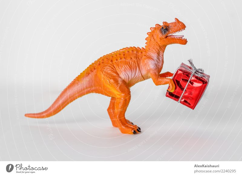 Dinosaur toy with christmas present box. Joy Playing Feasts & Celebrations To hold on Simple Friendliness Happiness Good Uniqueness Small Funny Original