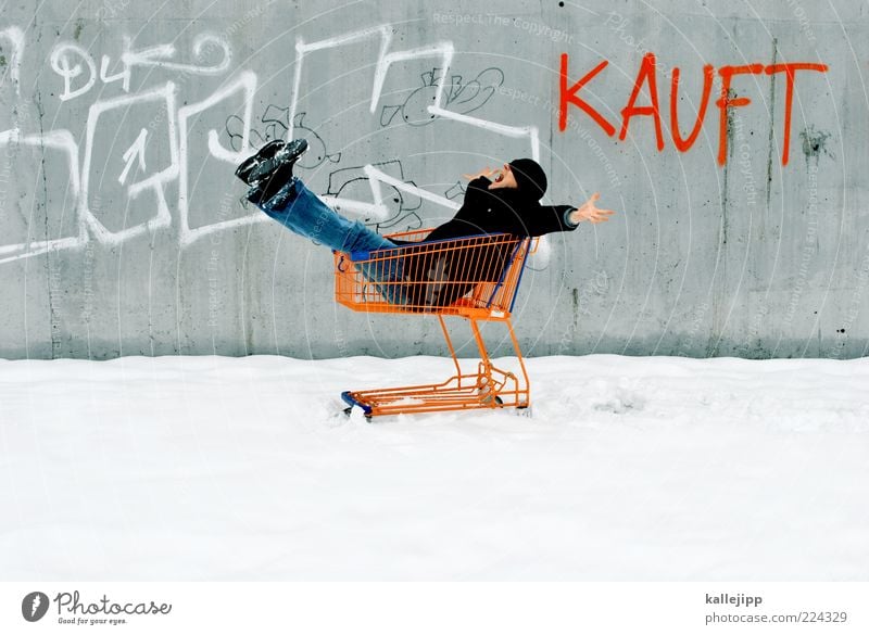 winter sales Lifestyle Shopping 1 Human being Winter Ice Frost Snow Jeans Coat Cap Characters Graffiti Free Happiness Shopping Trolley Consumption Concrete