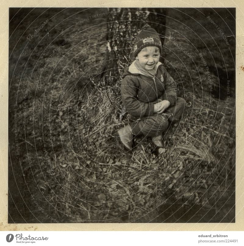 Remember me Infancy 1 Human being 3 - 8 years Child Tree Grass Pants Jacket Cap Laughter Sit Retro Joy Happiness Contentment Enthusiasm Black & white photo
