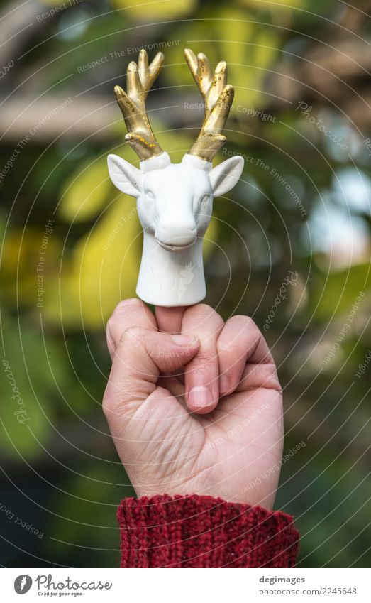 Statue of white deer on middle finger Human being Woman Adults Man Hand Fingers Aggression White Middle Deer horns Gesture Indicate sign Symbols and metaphors