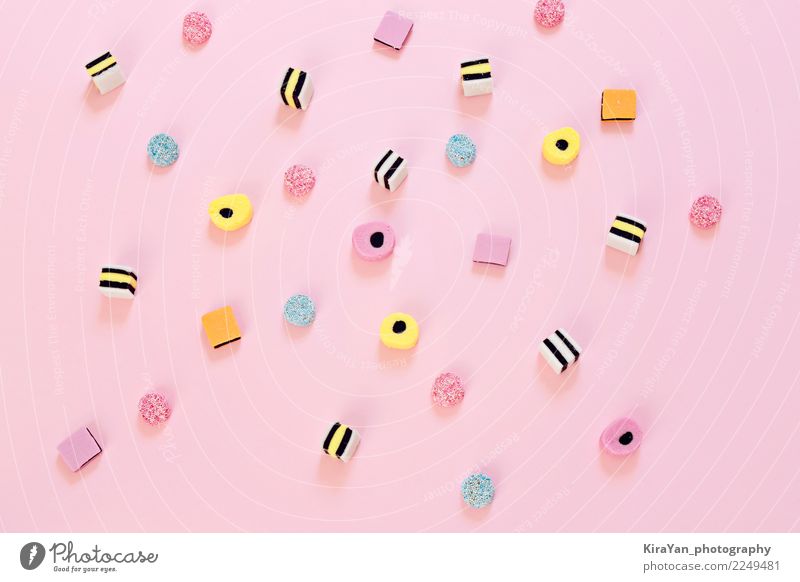 Colored candy scattered on the pink background Dessert Candy Eating Joy Party Feasts & Celebrations Group Exceptional Bright Delicious Blue Yellow Pink Colour