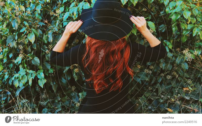 Back view of a redhead woman in a green garden Lifestyle Elegant Style Hair and hairstyles Human being Feminine Woman Adults 1 30 - 45 years Nature Plant Leaf