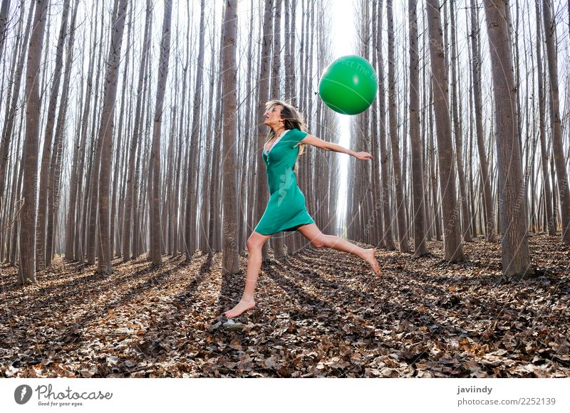 Blonde girl jumping into the woods with a balloon Lifestyle Joy Beautiful Relaxation Human being Woman Adults Nature Autumn Tree Leaf Park Forest Balloon Jump