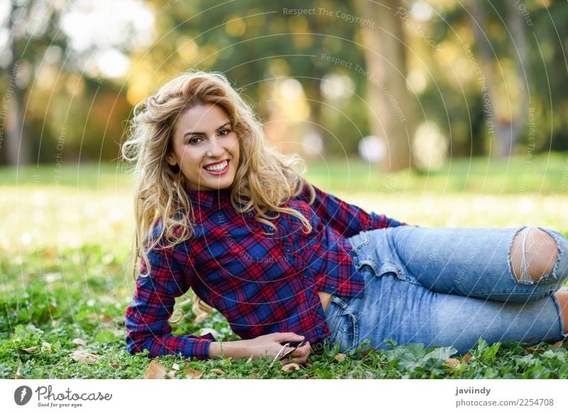 Woman smiling on the grass of a urban park Lifestyle Joy Happy Beautiful Hair and hairstyles Relaxation Human being Feminine Young woman Youth (Young adults)