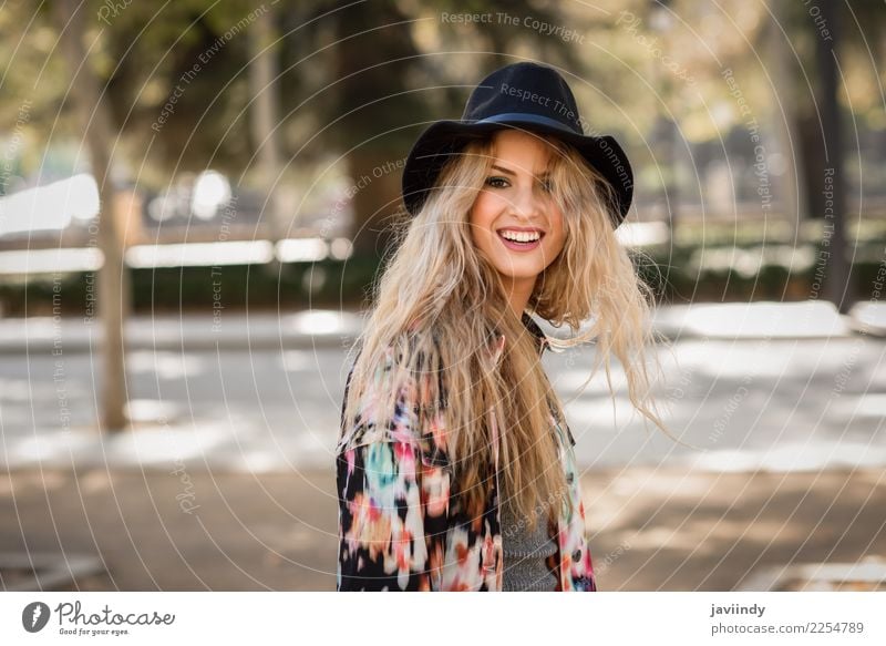 Smiling blond woman with hat in urban background Happy Beautiful Hair and hairstyles Human being Feminine Young woman Youth (Young adults) Woman Adults 1 Autumn