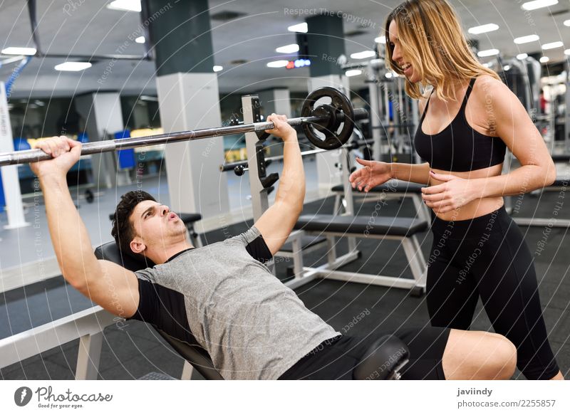 Female personal trainer motivating a young man lift weights Lifestyle Body Sports Human being Masculine Feminine Young woman Youth (Young adults) Young man