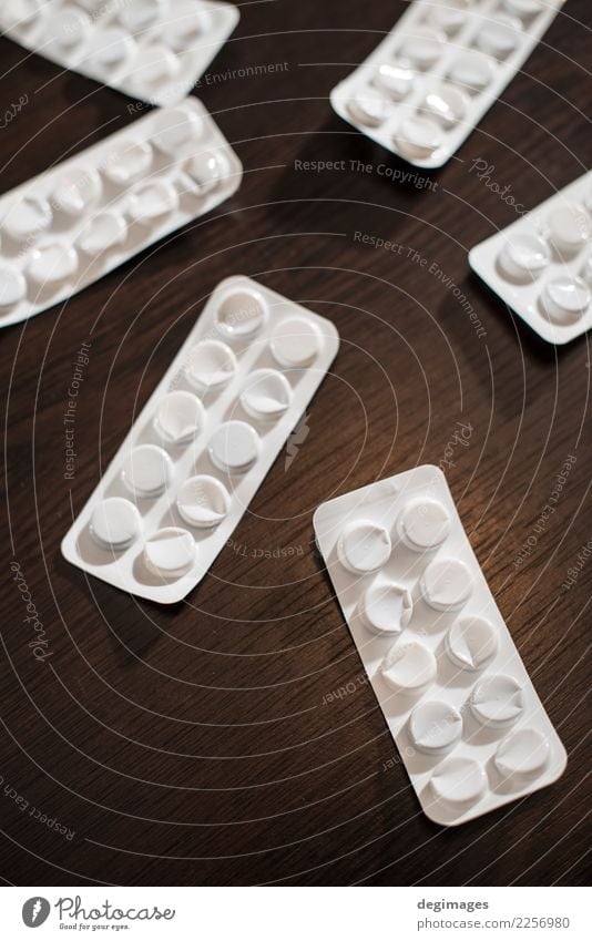 White blisters with drugs on dark Medical treatment Illness Medication Pack Packaging Package Plastic Dark Blister medicine Pill background Pharmacy health