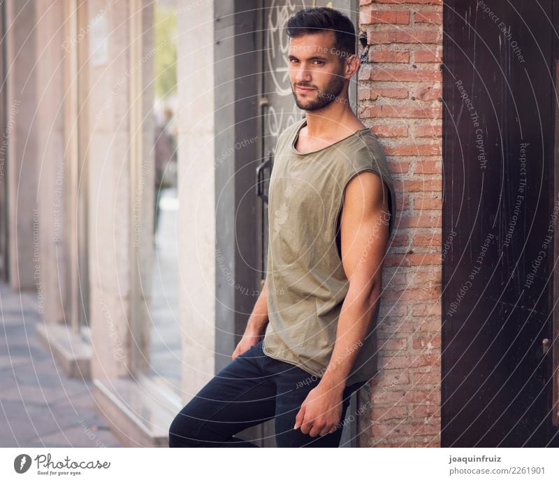 young handsome man with t-shirt against a wall in street Lifestyle Style Happy Human being Boy (child) Man Adults Town Street Fashion Jeans Cool (slang)