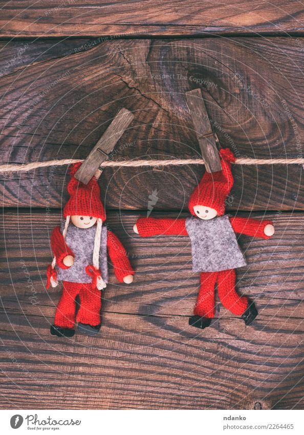 two wooden dolls hang on a rope, Child Rope Toys Doll Wood Small Brown Red Hanging Clothes peg christmas background vintage Rustic Colour photo Deserted