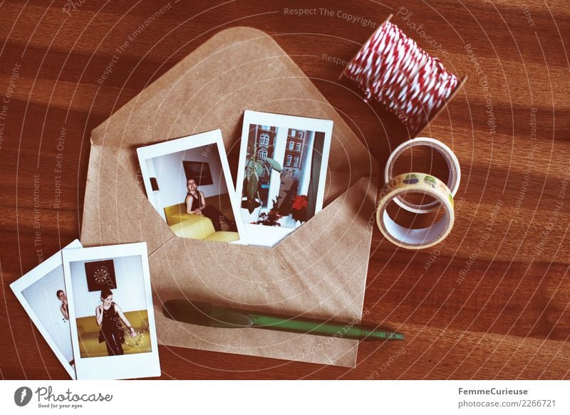 Instant pictures and envelope on table (02) Feminine Young woman Youth (Young adults) Woman Adults 1 Human being 18 - 30 years Communicate Memory Salutation