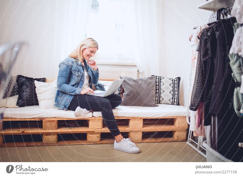 Young woman sitting on diy couch with notebook Lifestyle Shopping Living or residing Flat (apartment) Interior design Room Living room Human being Feminine