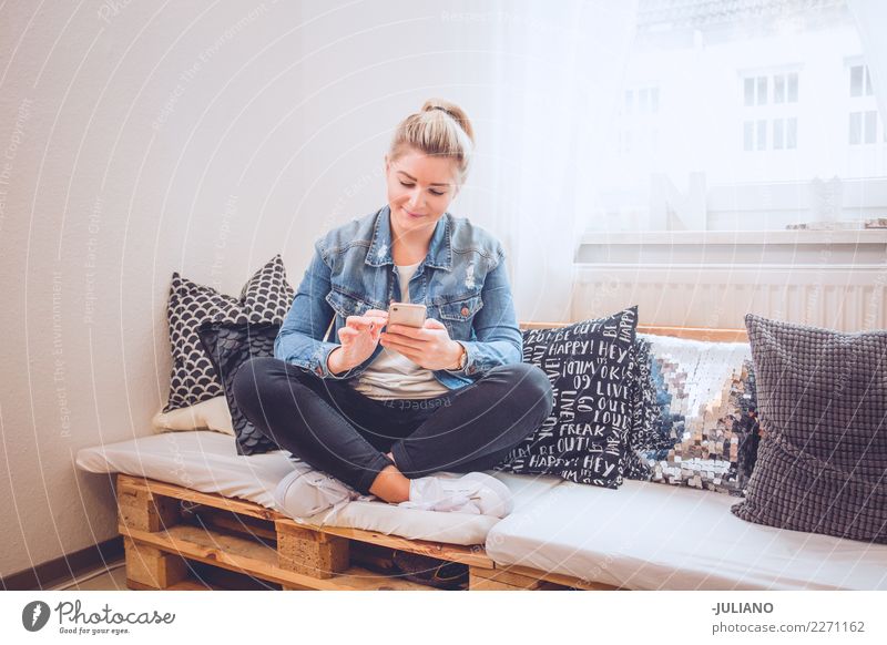 young woman sitting on her diy couch with phone Lifestyle Shopping Vacation & Travel Living or residing Flat (apartment) Interior design Room Living room