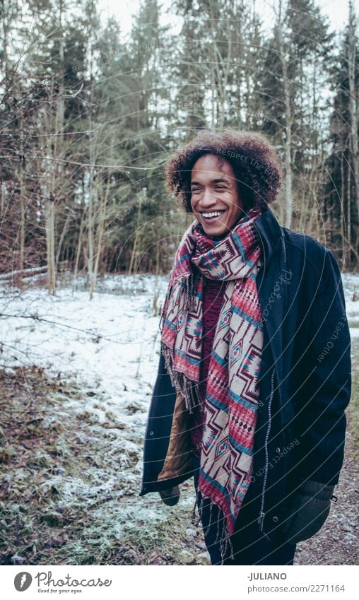 Young smiling man is taking a walk trough woods in winter Lifestyle Style Leisure and hobbies Winter Snow Winter vacation Human being Masculine Young man