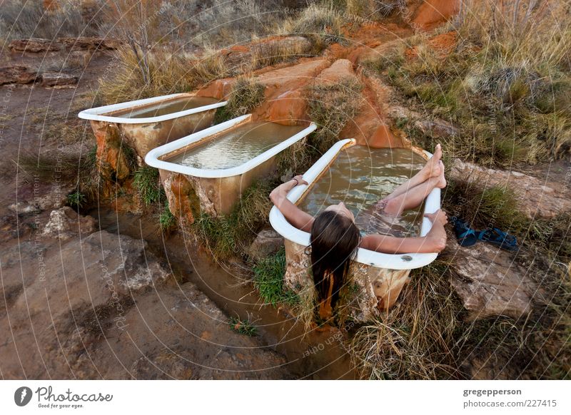 Young woman relaxing in a natural hot springs.. Well-being Contentment Relaxation Meditation Spa Swimming & Bathing Bathtub Personal hygiene Colour photo
