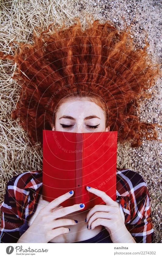 Young redhead woman reading a red book Lifestyle Style Beautiful Well-being Senses Relaxation Leisure and hobbies Reading Education Student Human being Feminine