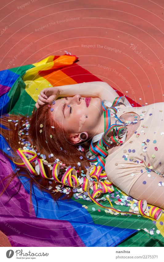 Young woman lying down over a rainbow flag Lifestyle Style Exotic Beautiful Hair and hairstyles Wellness Relaxation Calm Party Event Going out