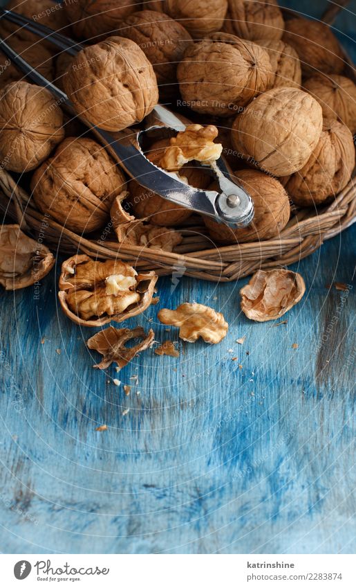 Fresh walnuts with a nutcracker Nutrition Vegetarian diet Table Group Old Natural Blue Brown Gray antioxidant appetizer broken Crack & Rip & Tear food health