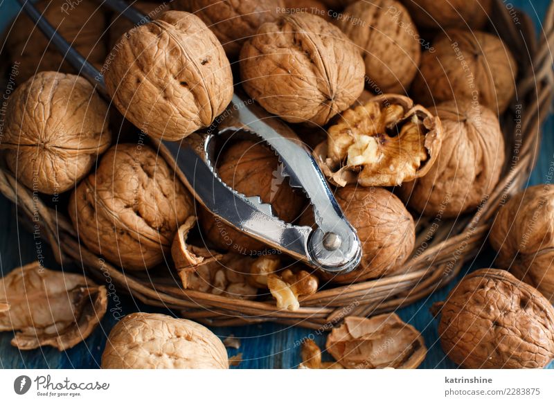 Fresh walnuts with a nutcracker Nutrition Vegetarian diet Table Group Old Natural Blue Brown Gray antioxidant appetizer broken Crack & Rip & Tear food health