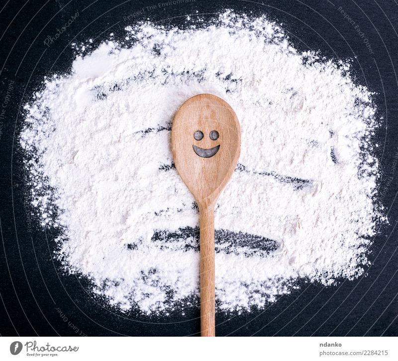 Wooden spoon with a carved smiling face Dough Baked goods Bread Nutrition Spoon Table Kitchen Eating Smiling Natural Black White cook Raw Flour food Consistency