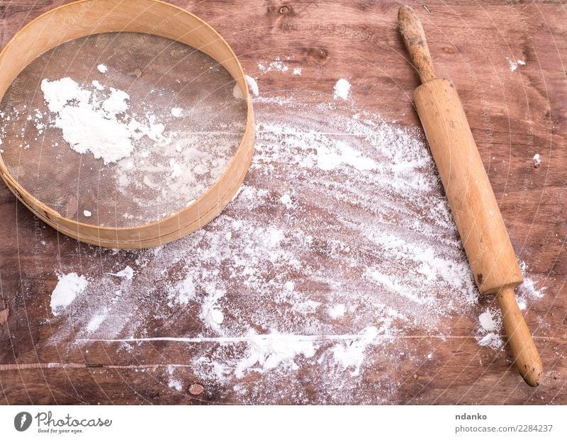 flour sprinkled on a brown wooden table Dough Baked goods Bread Table Kitchen Sieve Wood Retro Brown White Wheat Cooking Culinary Baking space board Consistency