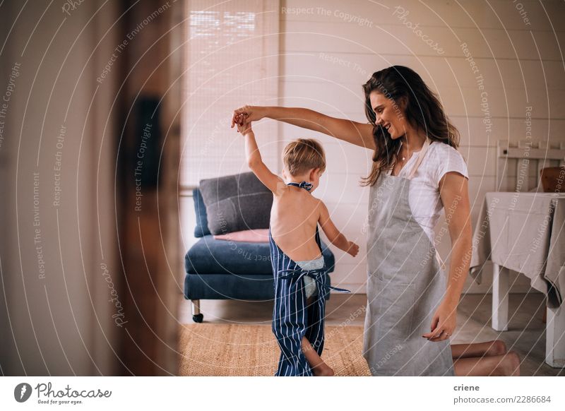 Mother dancing with toddler son in living room Joy Happy Kitchen Dance Child Human being Toddler Boy (child) Parents Adults Family & Relations 2 Together
