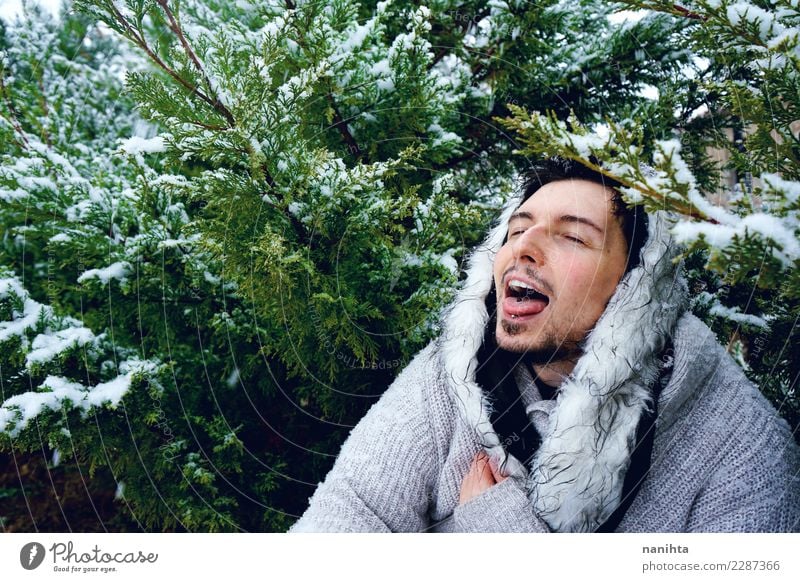 Young man enjoying the snow in a winter day Lifestyle Style Joy Wellness Well-being Winter Snow Winter vacation Human being Masculine Youth (Young adults) Man