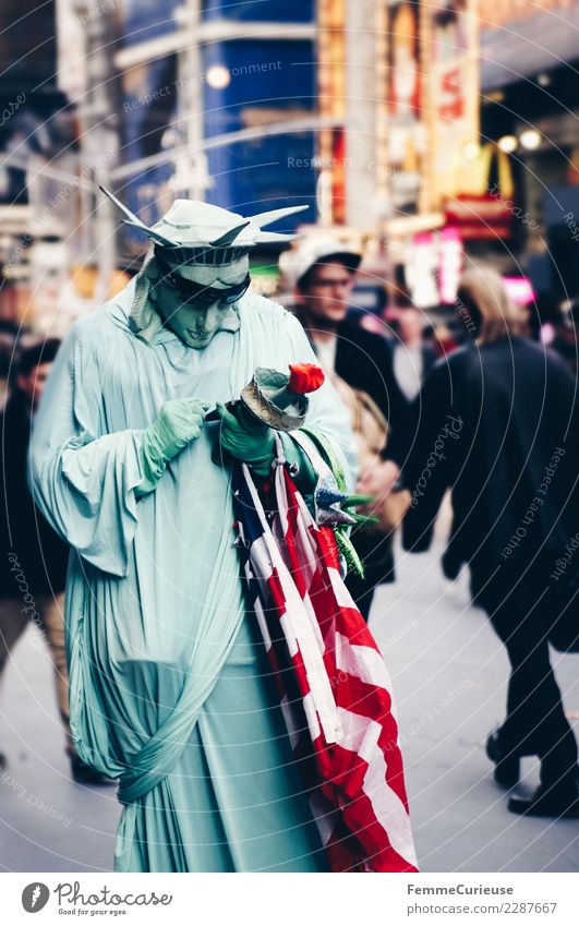 Person dressed as Statue of Liberty looking at mobile phone Sign Communicate Carnival costume Cellphone Computer network SMS Flag USA New York City Times Square